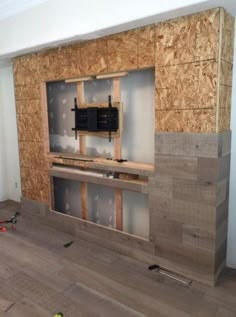 an unfinished living room with wood and plywood