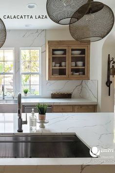 a kitchen with marble counter tops and wooden cabinetry, along with hanging baskets above the sink