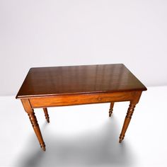 a small wooden table with two legs on one end and a single drawer on the other side