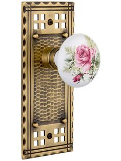 the rose knob is attached to an antique style doorknobl with decorative brass finish