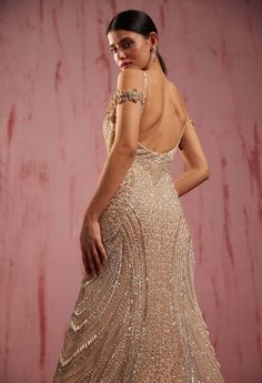 the back of a woman's dress with sequins and beads on it