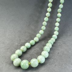 "Style: Estate Burmese jade round bead necklace, natural color fei cui, with a matching silver clasp. 65 beads Material: Natural Jadeite, jadeite, vintage, Burmese jade, green, silver clasp Method: fine polished Type: Necklace, bead necklace Size: bead size gradual from 6.5 to 9.5mm, length 23.5\" no.12" Formal Single Strand Jade Necklace, Formal Jade Jewelry With Round Beads, Elegant Round Jade Beaded Necklaces, Classic Green Beaded Necklaces With Round Beads, Jade Gemstone Beads Necklaces, Classic Handmade Green Necklaces, Jade Beaded Necklaces With Gemstone Beads, Handmade Classic Beaded Necklaces, Classic Handmade Round Beaded Necklaces