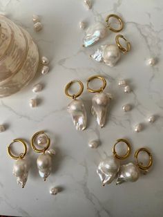 These baroque pearl earrings are completely PVD, which means you can wear them while chilling in the ocean, floating in the pool, or scrubbing it up in the bath. They are water-proof, sweat-proof and tarnish-proof.  Birth Of A Muse presents the 'classics'. Named because these pearls will simply never go out of style. I love the uniqueness of each pearl's natural shape, as they give a little more of a modern edge to a classic potato pearl.  Materials: Underneath the PVD coating, the drop is made Dream Items, Pvd Coating, Baroque Pearl Earrings, Jewelry Safe, A Muse, Gold Pearl Earrings, Pearl Hoop Earrings, Jewelry Lookbook, Keshi Pearls