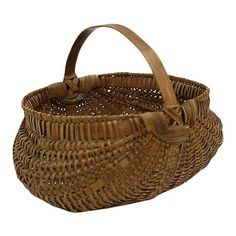 a brown wicker basket with handles on a white background for use as a purse or tote bag