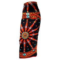 Presenting a printed silk tapered maxi skirt designed by Dolce and Gabbana for their Fall/Winter 1998 collection. Debuting in the season's runway presentation in black and navy, this piece features trim circular mirror appliqués attached with colorful embroidery. Sewn pleats at the hips create a ruching effect, emphasizing the piece's hourglass silhouette. Easy to dress up or down, this skirt would make a show-stopping addition to any wardrobe or collection! Approximate measurements: Size - remo Dolce And Gabbana Runway, Silk Maxi Skirt, Hourglass Silhouette, Colorful Embroidery, Circular Mirror, Chic Skirts, Donatella Versace, Silk Maxi, Printed Maxi Skirts