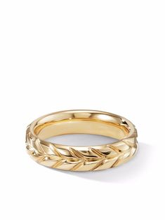 a gold wedding band with leaves on the inside and outside, set against a white background