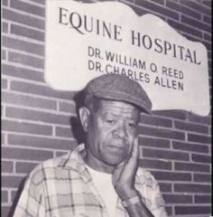 an old black and white photo of a man in front of the equinne hospital