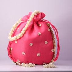 Pink Pouch Evening Bag For Wedding, Traditional Pink Shoulder Bag For Evening, Elegant Pink Shoulder Bag For Festivals, Formal Potli Gift Bag For Festivals, Elegant Red Potli Bag For Wedding, Handmade Handheld Potli Bag For Celebration, Traditional Red Shoulder Bag For Wedding, Festive Pink Handcrafted Shoulder Bag, Pink Rectangular Shoulder Bag For Wedding