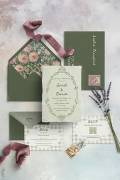 the wedding stationery is laid out on top of each other