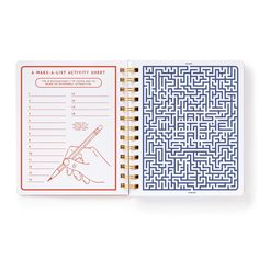 a notebook with an activity sheet inside and a hand holding a pen in the middle