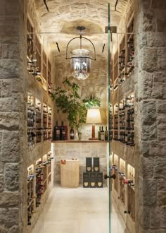 a wine cellar with stone walls and shelves filled with bottles