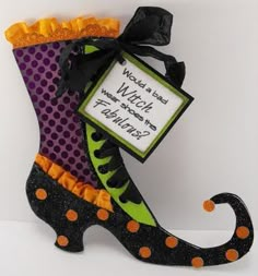 a halloween boot ornament with a sign attached to it