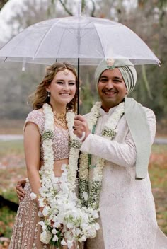 a man and woman standing under an umbrella