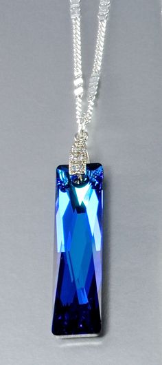 Unique and with a geometric appeal, this necklace will transform any day into a special event. All eyes will be on you, so prepare yourself for a fun adventure every time you wear it! Featuring a flawless 38x10mm Swarovski Queen Baguette Crystal that captures the light from every angle, the pendant is set on a bail studded with clear cubic zirconia and hangs on a delicate sterling silver chain, 18" long. Choose between 5 unique colors, some of the best among Swarovski's innovative palette: 1. Be Clear Crystal Necklace, Fun Adventure, All Eyes, Amazing Adventures, Bridal Necklace, Unique Colors, Clear Crystal, Sterling Silver Chains, Swarovski Crystal