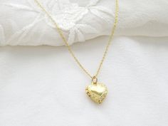 This dainty gold heart locket is a perfect gift for Valentine's Day, Weddings or Birthdays. 13 mm heart locket (can open) 17 inch gold plated chain Gold Heart Pendant Locket Necklace For Wedding, Gold Locket Necklace For Wedding On Valentine's Day, Gold Heart Charm Locket Necklace For Wedding, Dainty Charm Necklaces With Locket For Wedding, Dainty Locket Necklace For Gift, Locket Necklace For Valentine's Day Wedding, Dainty Locket Charm Necklaces For Wedding, Dainty Heart Pendant Locket Necklace For Wedding, Dainty Locket Necklace With Delicate Chain For Gift