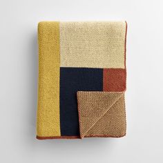 a blanket with two different colored squares on the front and back, one is folded up