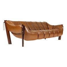 a brown leather couch sitting on top of a wooden frame