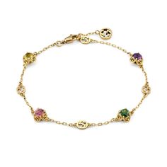 Classic elements come together atop this Gucci yellow gold bracelet, allowing it to be worn again and again. The delicate chain is enriched with precious stones that mix with the House's monogram. The style is completed by an Interlocking G charm at the closure. 18k yellow gold Interlocking G details Beryl, tourmaline and amethyst gemstones 4 gemstones, totaling approximately .87 carats 6.7 inches in length Made in Italy Gucci Style #: YBA662430001017 Designer Bracelet With Adjustable Chain For Gifts, Designer Bracelets With Adjustable Chain For Gifts, Gucci Jewelry With Jubilee Bracelet For Formal Occasions, Gucci Jubilee Bracelet For Formal Occasions, Luxury Gold Bracelets With Gemstones, Yellow Gold Bracelets With Jewels In Fine Jewelry Style, Elegant Gucci Bracelets For Gift, Luxury Yellow Gold Diamond Bracelet With Gemstones, Gucci Jubilee Bracelet Jewelry For Formal Occasions