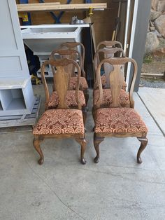 three chairs sitting next to each other in front of a building