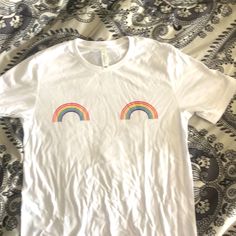 White Cotton Tshirt With Small Rainbows On Chest. Never Worn. Cotton T-shirt With Rainbow Print For Pride, Trendy Cotton T-shirt With Rainbow Print, White Screen Print T-shirt For Pride, Trendy Rainbow T-shirt For Pride, Trendy Rainbow Pride T-shirt, White Cotton T-shirt With Rainbow Print, Trendy Rainbow Graphic Print Tops, Trendy Graphic Print Pride Tops, Cute White T-shirt With Rainbow Print