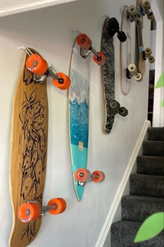 several skateboards are hanging on the wall next to some stairs and carpeted steps