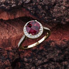 This garnet engagement ring in 14K white gold features a round garnet center stone that is complemented by brilliant white, sparkly diamond side stones. Garnet Engagement Details: 100% Handmade in the USA Center Stone - Garnet (2.00 carat AAA / VS) Metal - 100% Solid 14K (In Rose, Yellow, or White) Diamond Side Stones: Carat Weight - 0.33 carat total weight Shape - Round Cut Diamonds Color - G - H Clarity - SI1 Finger Size: We can make this setting in any finger size you need! Contact us if you Elegant Garnet Birthstone Ring With Center Stone, Luxury Garnet Ring With Center Stone, Formal Garnet Diamond Ring With Accent Stones, Fine Jewelry Round Cluster Ring With Garnet, Fine Jewelry Garnet Cluster Ring, Formal Round Garnet Cluster Ring, Ruby Ring With Diamond Accent Stones, Lab-created Ruby Diamond Ring With Round Cut, Garnet Gemstone Cluster Ring