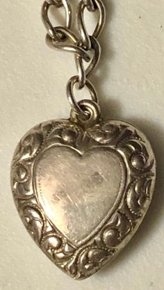 "This is a fabulous mini-collection of sterling silver hearts on a silver bracelet, ready to wear and add on if desired. You are buying FOUR puffy heart charm pendants for ONE price. They are ALL sterling silver and stamped. All of these hearts appear to be older, non-repros, dating to the early 1900s. They are on a 7\" silver (unmarked) charm bracelet and weigh a total of 8.7 grams. In very good vintage used condition, these are all sold as found, unpolished, lovely patina, all original and fre Valentine's Day Silver Heart Bracelet, Anniversary Heart Pendant Charm Bracelet, Silver Double Heart Charm Bracelet For Valentine's Day, Heart-shaped Hallmarked Bracelets As A Gift, Silver Heart Bracelet With Sterling Clasp For Valentine's Day, Silver Heart Bracelet With Sterling Silver Clasp, Silver Heart Bracelet With Charms For Anniversary, Heart Charm Bracelet For Anniversary, Silver Engraved Heart Bracelet For Valentine's Day