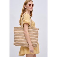 The epitome of laid-back chic, perfect for beach days or farmer's market strolls! With a breezy open closure and a woven all-over exterior featuring a stripe design, this tote effortlessly combines style with functionality. Inside, the printed fabric lining, 1 zip pocket, and 2 slip pockets make it your go-to for a fashionable and organized outing. Embrace the sunshine with a tote designed for those sunny adventures! Item Type: Tote Material: Straw Closure: Open Exterior Details: Woven All-over, Everyday Striped Straw Bag, Woven Striped Bags, Striped Woven Tote Bag, Striped Shoulder Bag With Braided Handles, Casual Striped Woven Bag, Spring Beach Bag In Sand Color, Striped Woven Straw Bag, Casual Cream Straw Beach Bag, Striped Woven Rectangular Straw Bag