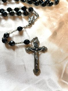 Authentic 1950s Vatican City Rosary . Black Murano glass beads adorn a beautiful rosary with detailed intricate depictions of Christ.  You don't have to be a theology buff to love this Italian treasure .  This was purchased at an estate sale of a woman who had so many beautiful pieces from Italy 🇮🇹. A ton of religious relics and medals. Be sure to grab this beautiful Rosary and have it in your collection.  $85 plus shipping of your choice Vintage Cross Jewelry With 8mm Beads, Vintage Cross Necklace With 8mm Beads, Vintage Cross Necklaces With 8mm Beads, Vintage Black Rosary As Gift, Vintage Black Rosary Gift, Vintage Black Rosary As A Gift, Vintage Beaded Crucifix Jewelry, Vintage Silver Rosary With Round Beads, Vintage Beaded Rosary As Gift