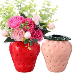 two ceramic vases with flowers in them on a white background, one is red and the other is pink