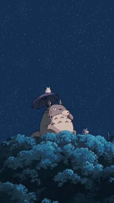 a person holding an umbrella standing on top of a lush green hillside under a night sky