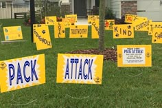 many signs are placed on the grass in front of a house that says,'pack attack '