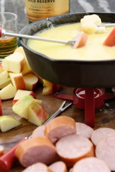 a pan filled with food sitting on top of a table next to sliced up apples