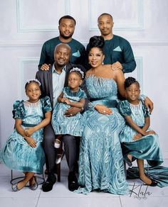 the family is posing for a photo in their blue dress and matching outfits with each other