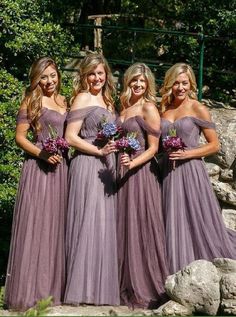 the bridesmaids are all wearing purple dresses