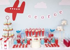 an airplane themed birthday party with cupcakes and desserts on the table in red, white and blue colors