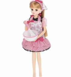 a doll holding a bowl and whisk