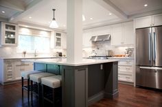 a kitchen with an island and stools in it