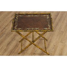 a small wooden table sitting on top of a hard wood floor