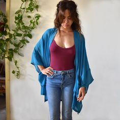 Handmade blue boho kimono robe cover up cardigan with pockets. Our kimono robe comes in a wide and loose style, one-size-fits all. Made in a vibrant turquoise blue viscose mix fabric with a light sheer, that is light and easy to wear. Finished with wide cotton quarter length sleeves in a warm mustard colour and large oversize pockets on each side. We have also added a slightly longer back panel for a more flattering fit. Pictured is our knee length version, but this kimono cardigan can be custom Oversized Blue Kimono For Beach Cover-up, Blue Open Front Summer Cardigan, Blue Flowy Cover-up With Kimono Sleeves, Summer Blue Relaxed Fit Outerwear, Blue Relaxed Fit Summer Outerwear, Blue Bohemian Robe With Kimono Sleeves, Blue Bohemian Cardigan For Summer, Bohemian Blue Cardigan For Summer, Blue Open Front Summer Outerwear