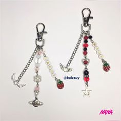 two key chains with charms attached to them