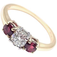 18k Yellow Gold and Platinum Diamond And Ruby Three Stone Band Ring by Tiffany & Co. With 1 Round Brilliant Cut Diamond VS1 clarity, G color, Total weight Approx .50ctw 2 Round rubies total weight approx. 0.50ct Details: Ring Size: 6 Width: 6mm Weight: 2.7 grams Stamped Hallmarks: Tiffany&Co 750 PT950 **Free Shipping within the United States** Your Price: $7,500 T2697oddd Luxury 14k Gold Ruby Ring With Brilliant Cut, Luxury Multi-stone Round Cut Ruby Ring, Luxury Ruby Ring With Multi-stone Round Cut, Luxury Round Cut Multi-stone Ruby Ring, Luxury Gold Three-stone Ruby Ring, Luxury Gold Ruby Three Stone Ring, Luxury Gold Three Stone Ruby Ring, Luxury Gold Ruby Ring With Three Stones, Three-stone Yellow Gold Ruby Ring