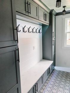 the inside of a kitchen with gray cabinets and white counter tops