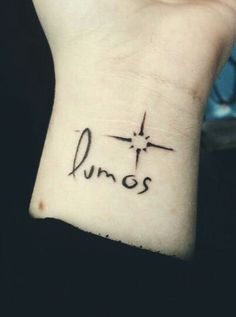 a wrist tattoo with the word junos written on it