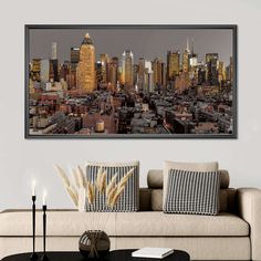 a living room with a couch, coffee table and pictures on the wall above it