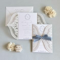 the wedding stationery is laid out on the table