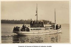 an old black and white photo of a boat with people on it in the water