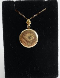 A cute old circle locket pendant with a lovely floral etching 1/20 12k gold filled chain and pendant. Older spring style clasp and delicate 20in chain. Cheap Antique Round Pendant Necklace, Gold Medallion Locket Necklace Stamped 14k, Antique Medallion Locket Necklace Stamped 14k, Hallmarked Medallion Necklace For Keepsake, Anniversary Yellow Gold Locket Necklace With Vintage Charm, Yellow Gold Locket Necklace With Vintage Charm For Anniversary, Vintage Yellow Gold Locket Necklace For Keepsake, Gold Locket Necklace With Vintage Charm, Gold Pendant Locket Necklace With Vintage Charm