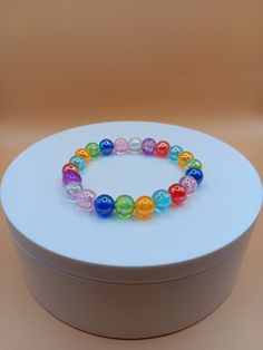 Colorful 8mm glass bead bracelet. It is beautiful in the light especially with all the colors. It can make a great gift for a loved one.  Bracelet is crafted with quality elastic stretch cord for the perfect fit. Bracelet sizes are from 6.5 inches to 8 inches. If your wrist size is not listed then please contact me with your wrist size. I will gladly do a special order. All items are made to order. They are shipped via United States Postal Service with a tracking number. Items will be shipped wi Hypoallergenic Rainbow Bracelets With Round Beads, Hypoallergenic Rainbow Beaded Bracelets, Rainbow Crystal Bracelet With Round Beads For Gift, Clear Beaded Bracelets For Gift, Clear Beaded Bracelets As A Gift, Multicolor 8mm Beads Stretch Bracelet As Gift, Multicolor Adjustable Pearl Bracelet With 8mm Beads, Adjustable Multicolor Pearl Bracelet With 8mm Beads, Multicolor 8mm Beads Wristband For Gift