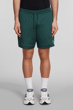 Shorts in green polyester, elasticated waistband, coulisse closure, perfored, side logo print, Made in Cambodia, Model is 1. 83 and wears size M Green Moisture-wicking Sportswear Bottoms, Green Nylon Sports Bottoms, Green Nylon Bottoms With Elastic Waistband, Green Cotton Athletic Shorts For Sports, Green Nylon Sportswear Shorts, Casual Green Nylon Athletic Shorts, Green Athletic Shorts With Elastic Waistband For Sports, Green Sports Shorts With Elastic Waistband, Green Sports Bottoms With Elastic Waistband